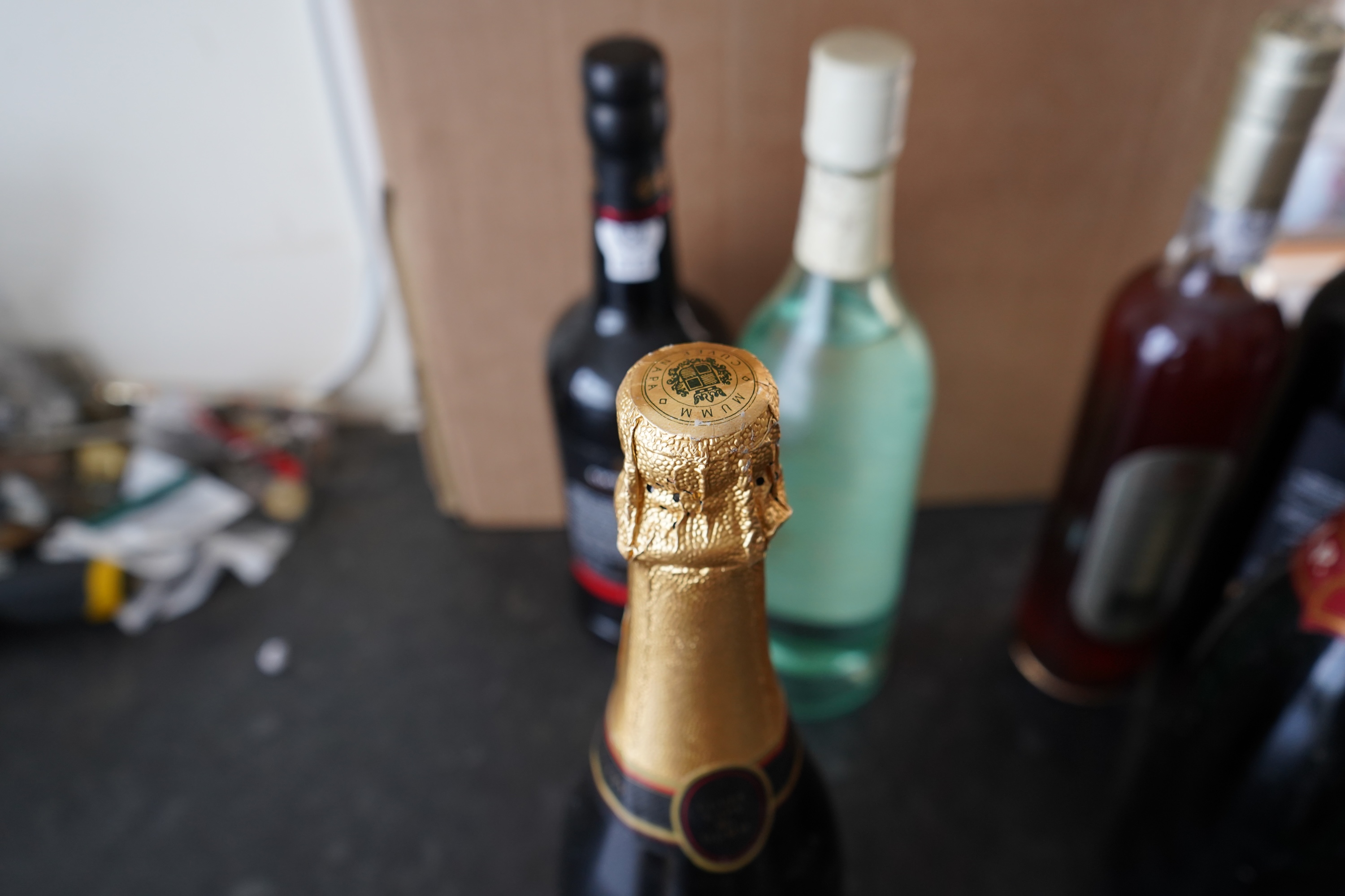 Eight bottles of champagne, port and rum to include Mumm, Laurent Perrier and Warres